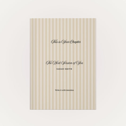 Front view of personalized hardcover journal with beige striped cover and custom name on a clean neutral background by Momentum Prints.