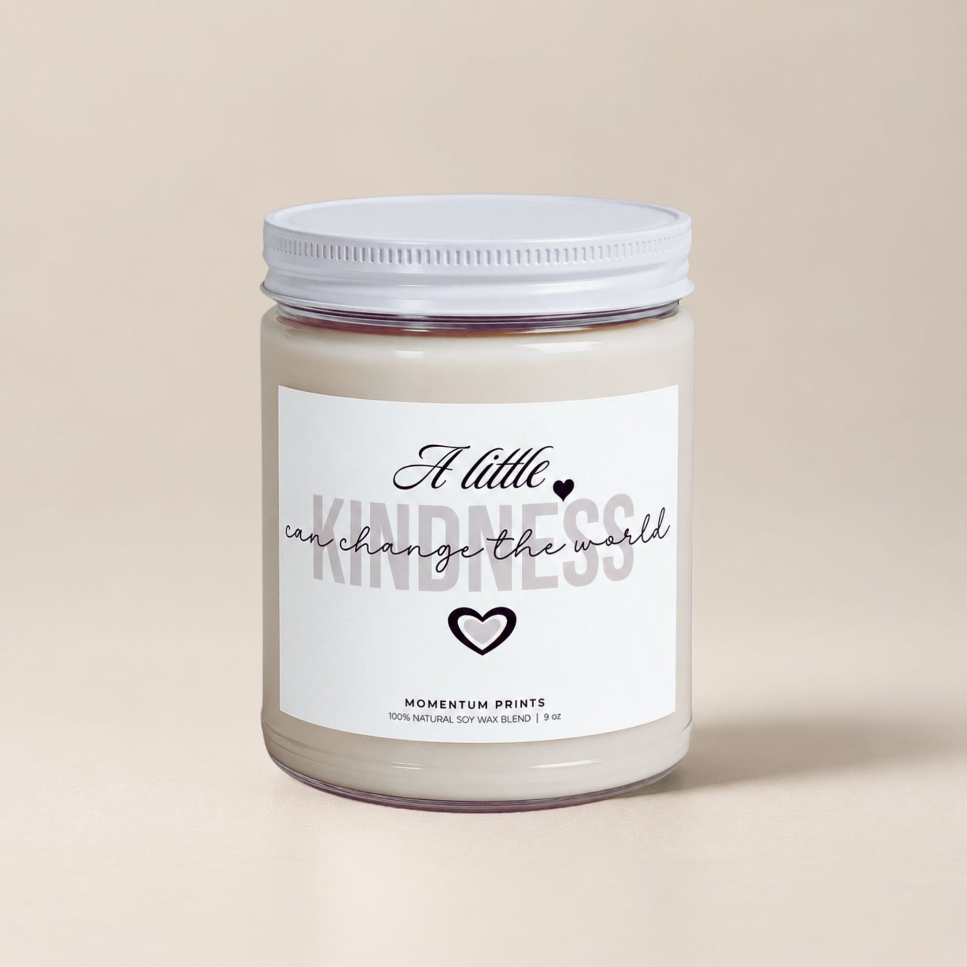 A Little Kindness Can Change the World scented soy candle by Momentum Prints with minimalist white label and soft beige background.