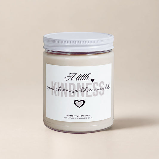 A Little Kindness Can Change the World scented soy candle by Momentum Prints with minimalist white label and soft beige background.