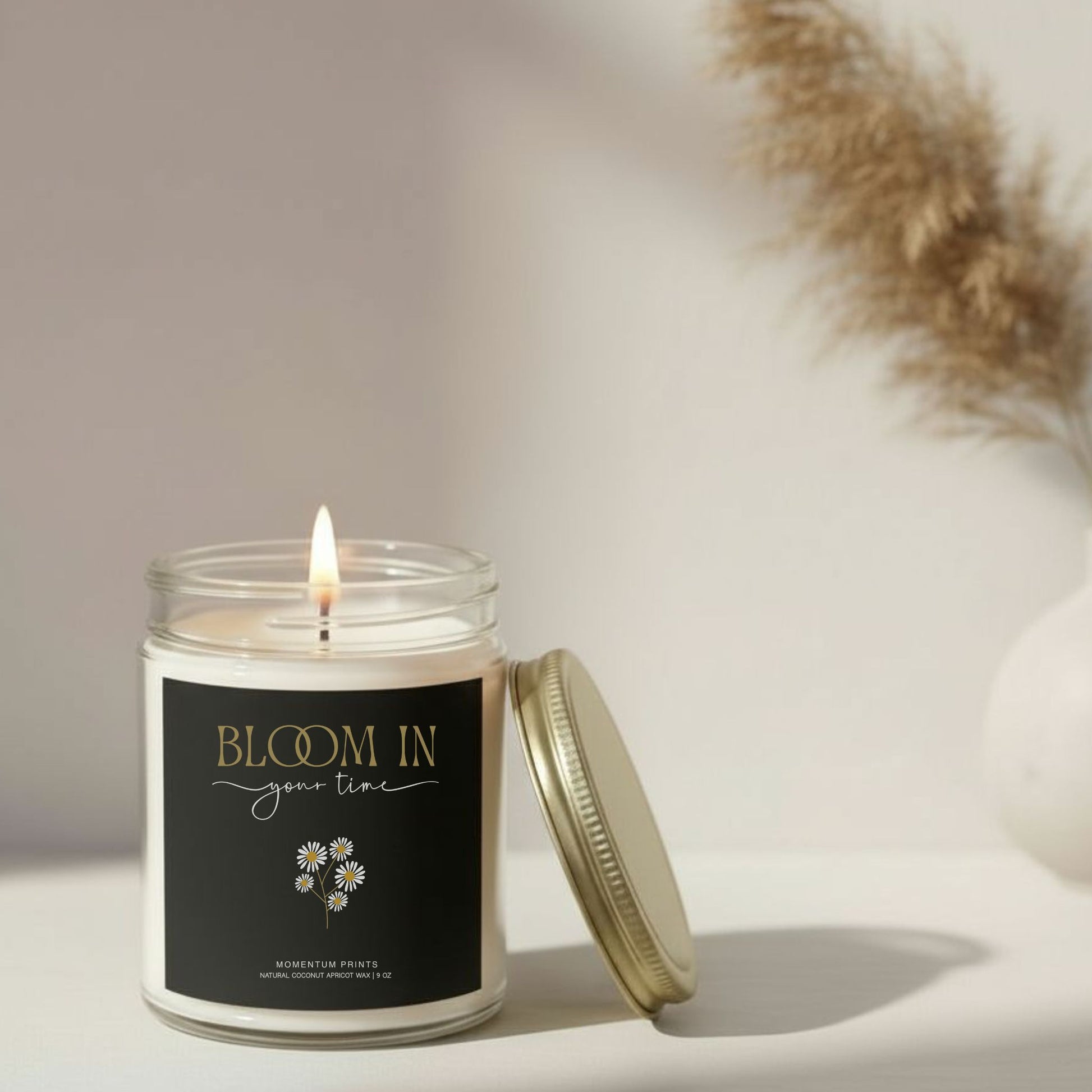 Bloom in Your Time” inspirational candle with soft flame on neutral beige background — elegant floral design by Momentum Prints.
