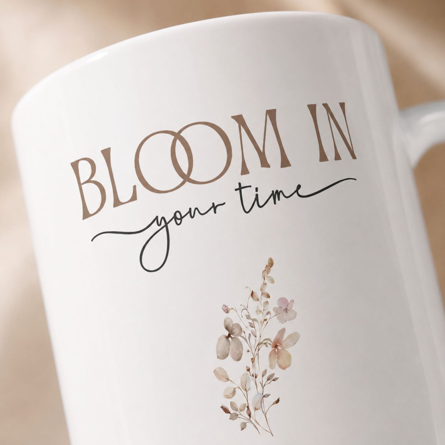 Detailed close-up of the Bloom in Your Time ceramic mug showcasing elegant typography and delicate floral artwork in a soft neutral color palette.