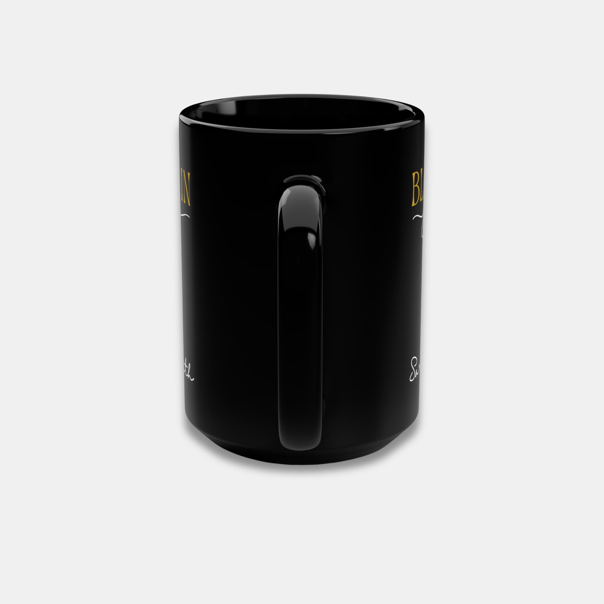 Black personalized mug with partial “Bloom in Your Time” design and handle-centered side view on a light background.
