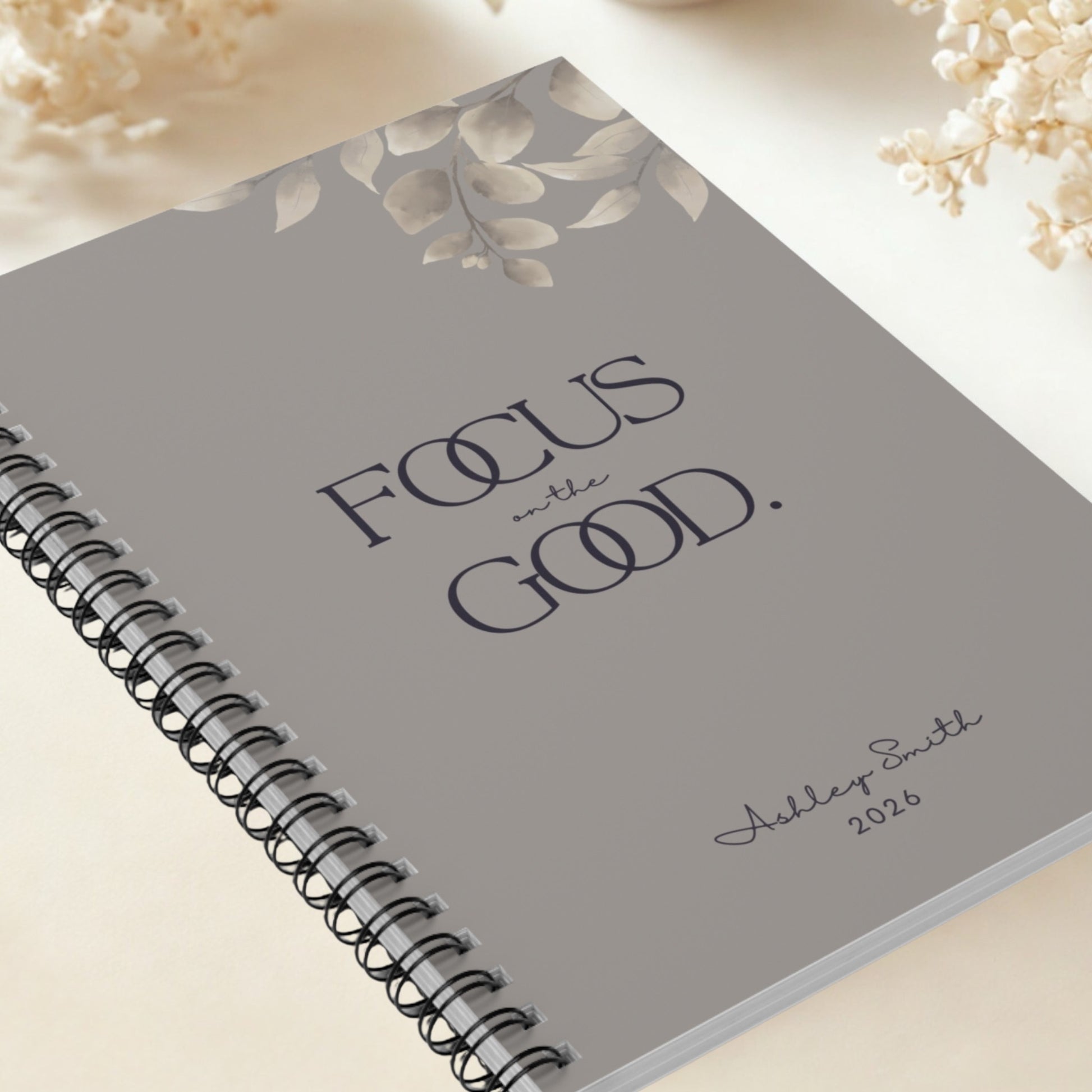 Premium close-up of Focus on the Good warm gray spiral notebook with refined minimalist cover design.