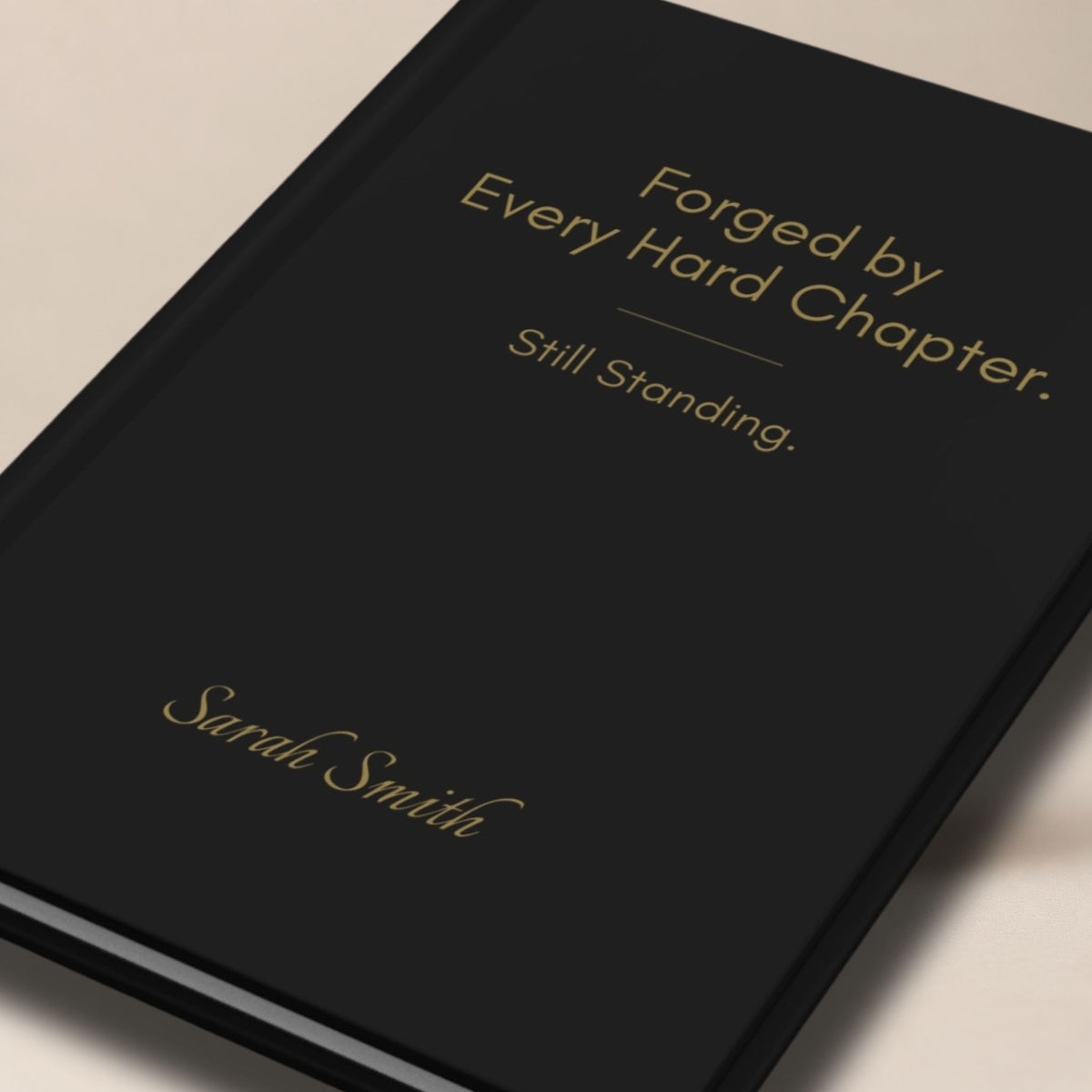 Close-up of a personalized black hardcover journal featuring elegant champagne gold typography and a minimalist premium cover design.