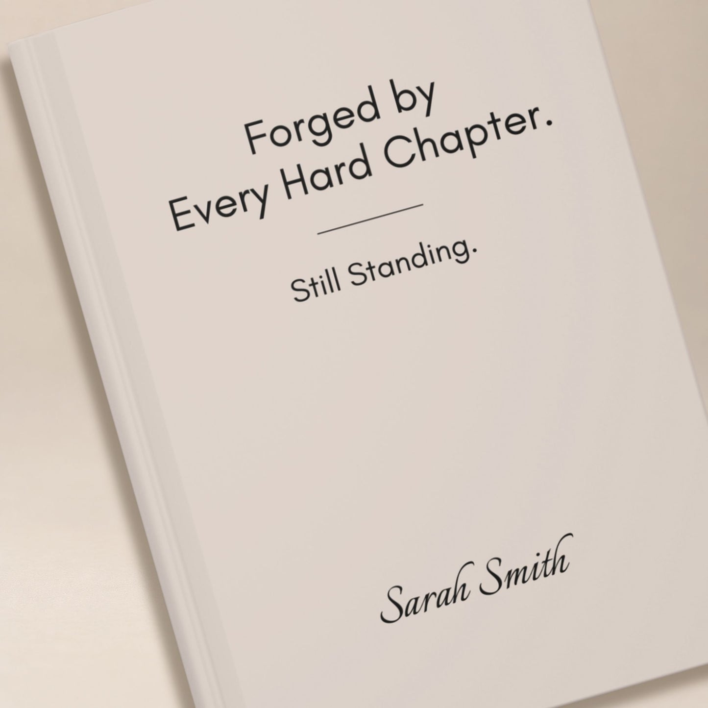 Close up detail of a personalized ivory hardcover journal cover, showing black lettering and a name in script typography by Momentum Prints.