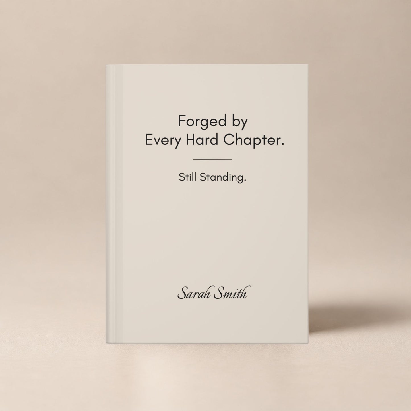 A personalized ivory hardcover journal standing upright against a soft beige studio background, showcasing the cover design by Momentum Prints.