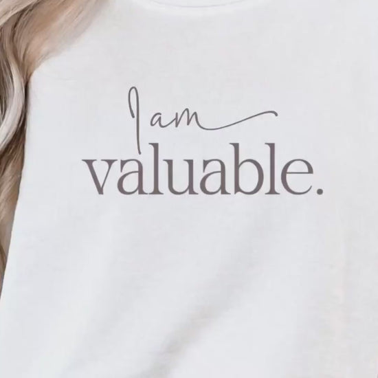 Minimal lifestyle scene featuring a woman wearing an ‘I am valuable’ sweatshirt