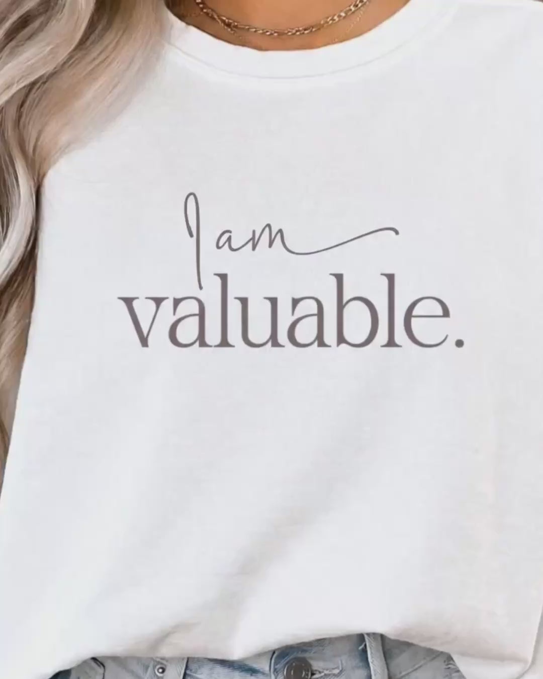 Minimal lifestyle scene featuring a woman wearing an ‘I am valuable’ sweatshirt