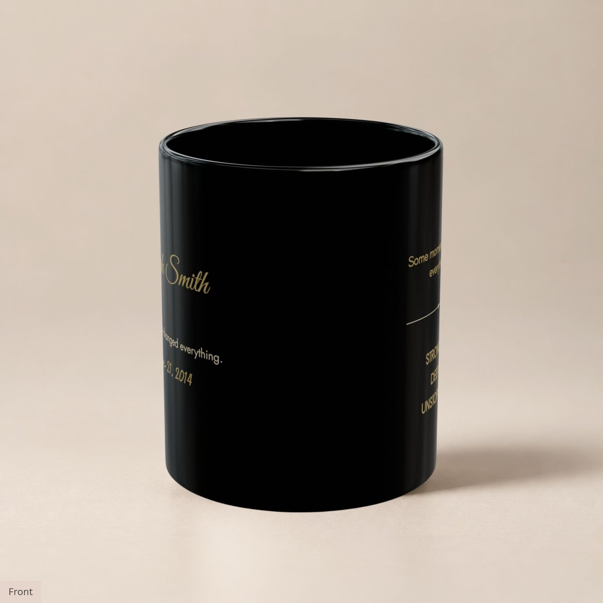 Black ceramic mug turned to reveal both the personalized name side and the gold lettered affirmation side, showcasing the dual design on a glossy matte black finish by Momentum Prints
