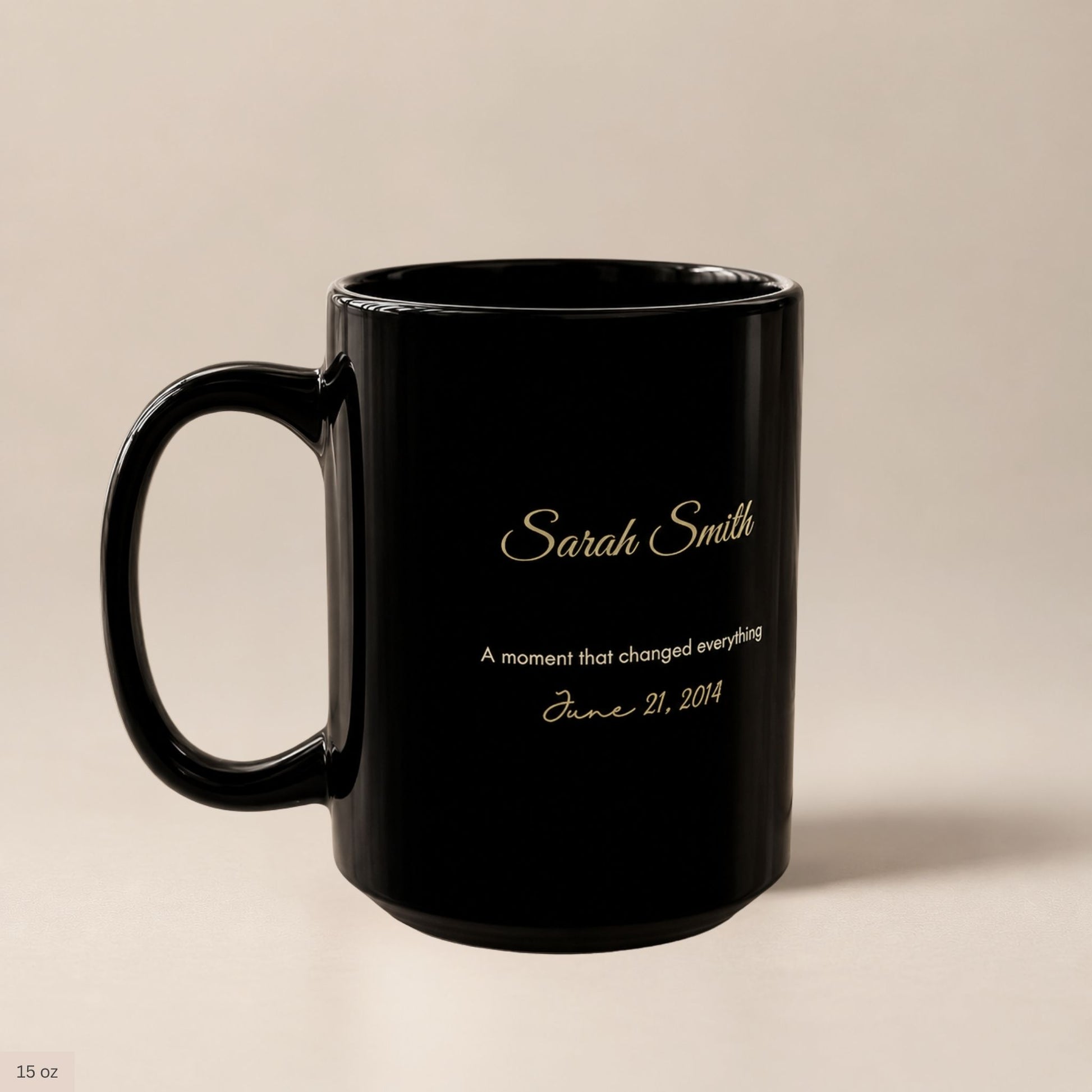 Premium personalized black ceramic mug with gold script name and cream lettering commemorating a meaningful date, styled on a soft beige backdrop by Momentum Prints.