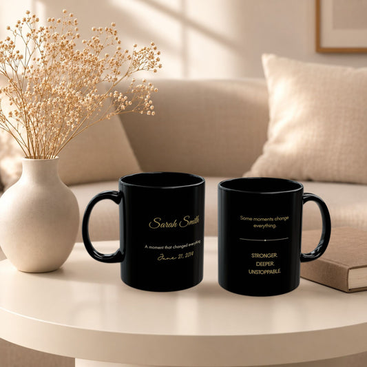 Two personalized black ceramic mugs arranged on a round white side table in a sunlit living room with beige upholstery and dried florals, in a luxury editorial lifestyle setting by Momentum Prints.