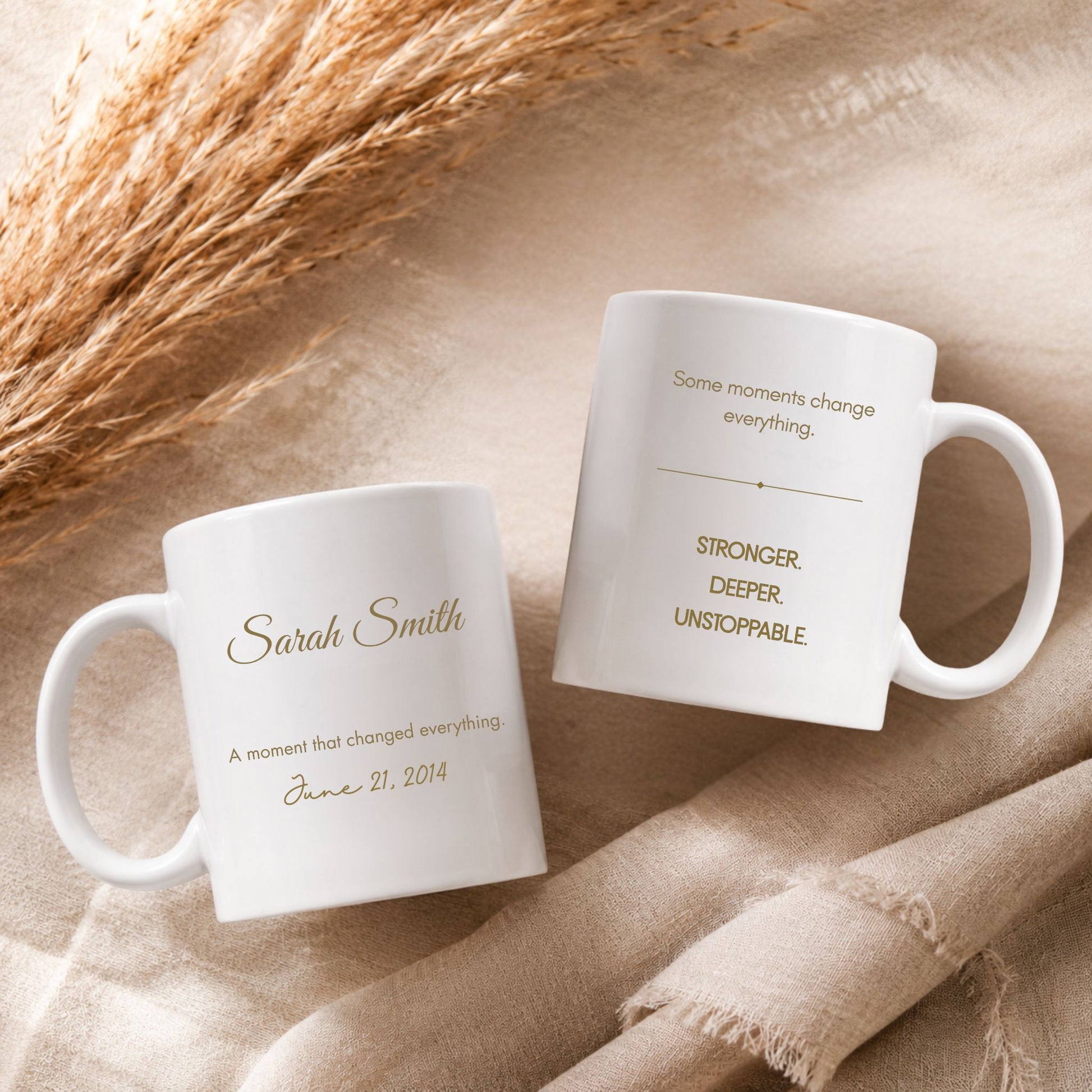 Personalized memory mug displaying a custom name, special date, and inspirational quote, photographed in a warm beige flatlay setting with soft fabric textures and pampas grass.