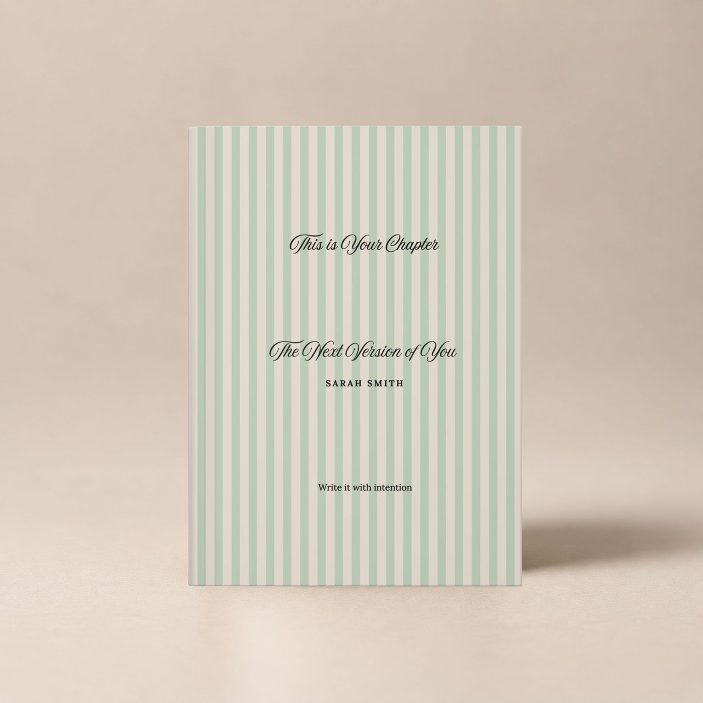 Front view of a premium personalized hardcover journal with a sage green striped cover and black script lettering, shown standing upright on a soft beige background by Momentum Prints.